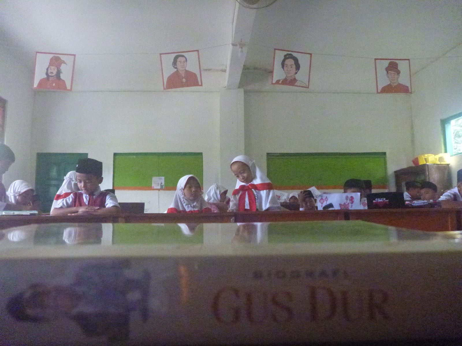 Seni grafis tergantung di ruang kelas MI Al Muttaqin Cilacap saat siswa mewarnai seni grafis Gus Dur pada Selasa (11/11/2025). (Dokumentasi MI Al Muttaqin)